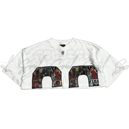 White sports jersey with decorative number design featuring various images and patterns.