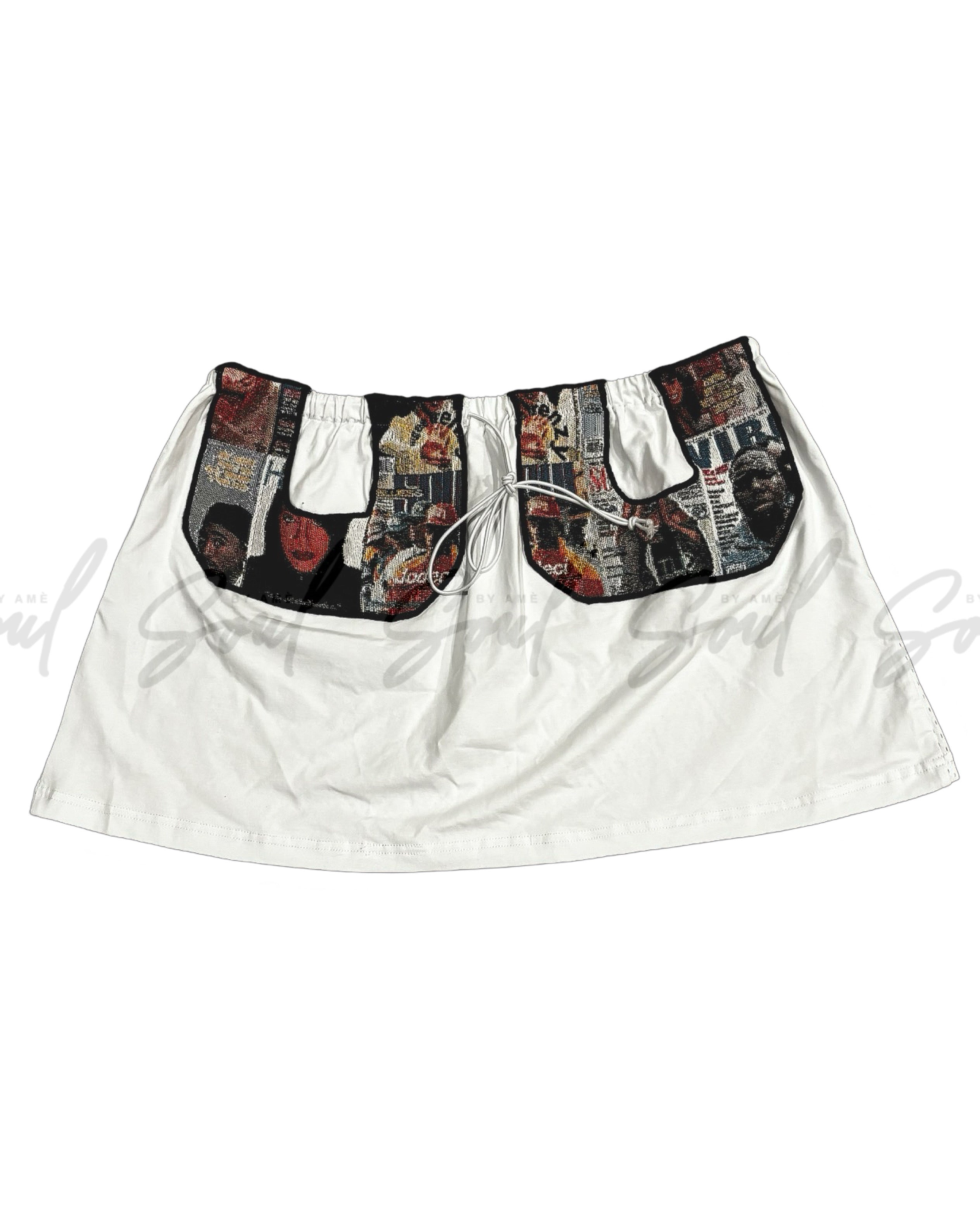 White skirt with decorative pockets featuring a collage-like print design.