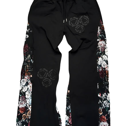 Black sweatpants with floral designs along the sides and gear-like patterns on the front.